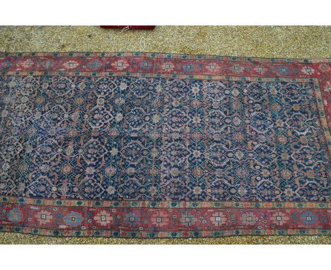 An antique Persian Farah kelleigh carpet, 1st quarter 20th century, the all-over linked geometric design on blue ground withi