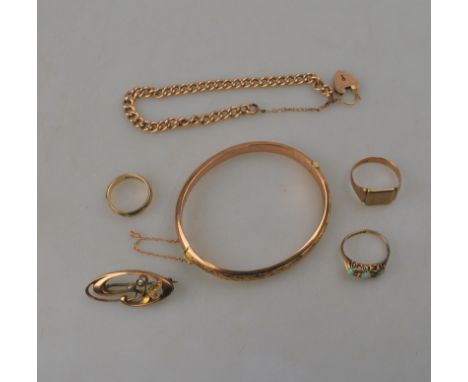 A signet ring with monogram initials stamped 9ct; wedding band stamped 9ct; three-stone opal set 9ct ring; a scroll brooch se