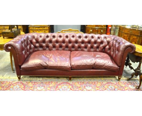 Howard Chairs Ltd, London, a contemporary bespoke deep burgundy buttoned leather Chesterfield sofa, raised on three square ta