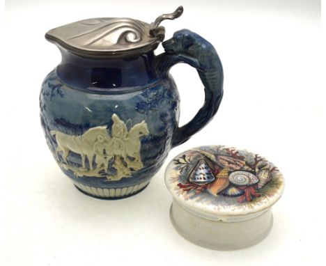 A early 19th century Wedgwood blue and white jug moulded with hunting scenes and having a hound moulded handle and later pewt