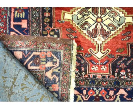 A contemporary Persian Hamadan rug, the geometric triple diamond design on pale red ground, 1.97 x 1.28 m