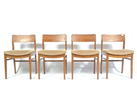 A set of four late 20th Century retro vintage teak wood dining chairs having a an upholstered seat pad, show wood teak panel 