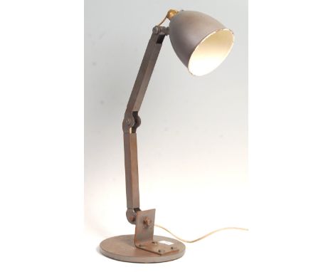 An original mid 20th Century retro vintage industrial factory work desk lamp having a bell shaped enamel shade raised on arti