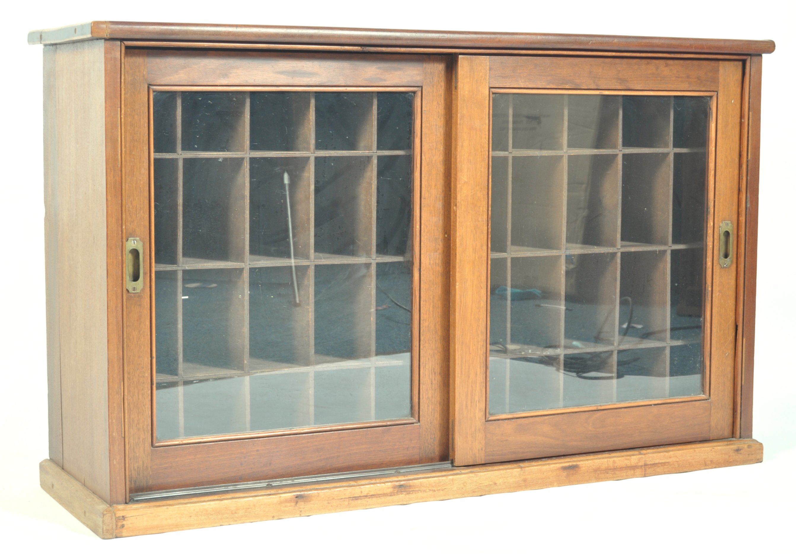 An early 20th Century mahogany cased pigeon hole cabinet having twin ...