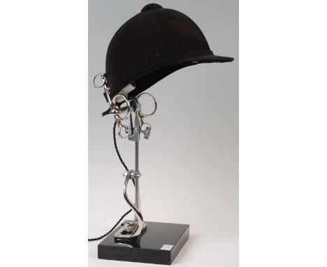 An unusual 20th Century contemporary Equestrian interest table lamp comprising of a velvet riding hat / helmet mounted on adj