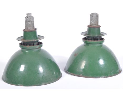 A pair of large 20th Century retro vintage industrial porcelain enamel pendant light shades in the usual green exterior and w