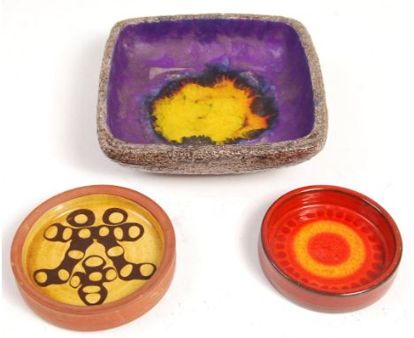 A set of three mid 20th Century retro vintage studio art pottery dishes to include; Large square dished bowl with textured gr