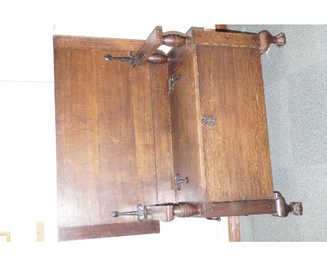 Metamorphic oak Monk's bench, iron stap hinges and loop handles, turned supports, carried on ball and claw feet, height (in b