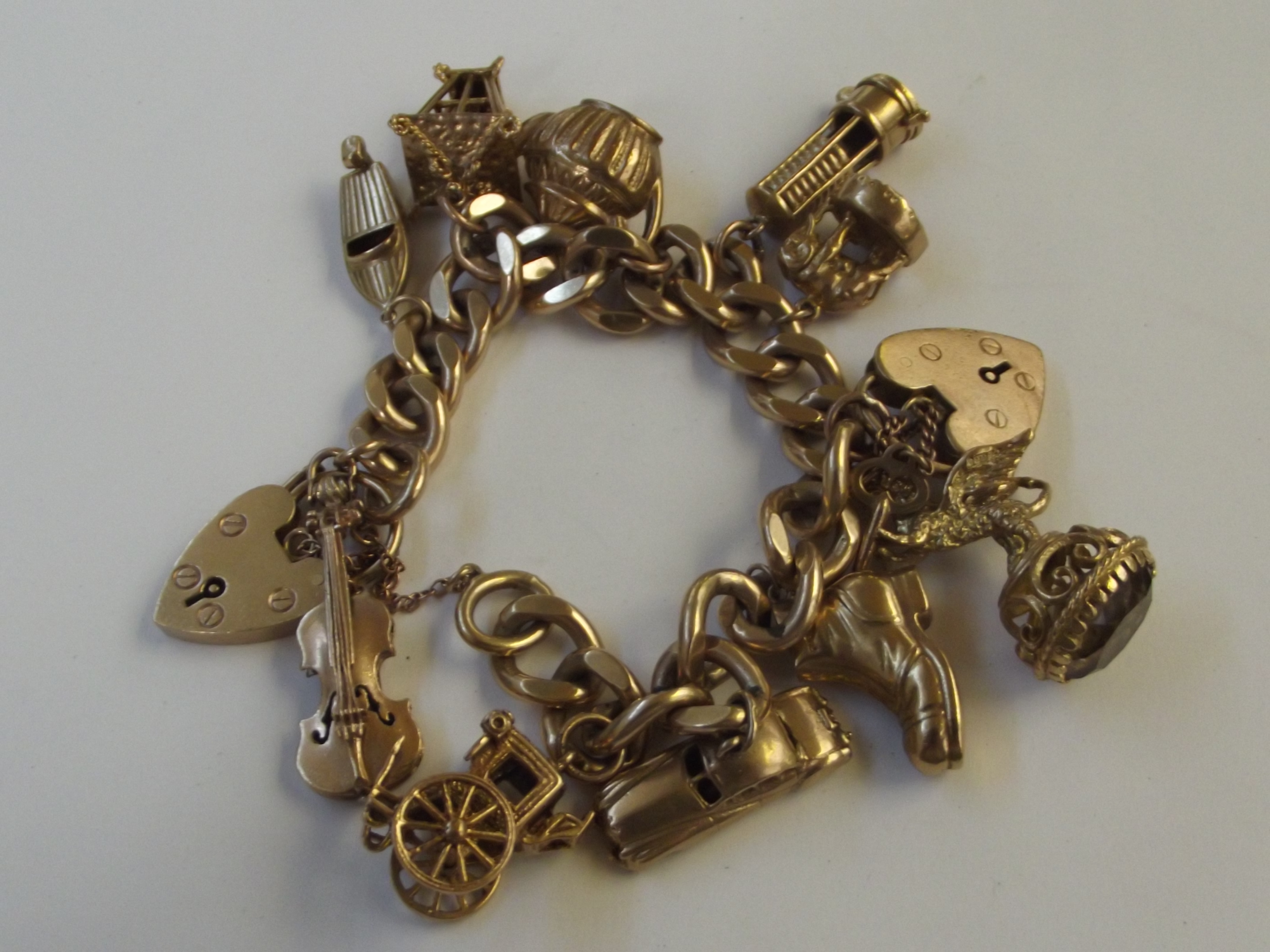 9 carat gold charm bracelet, weight 88 grams