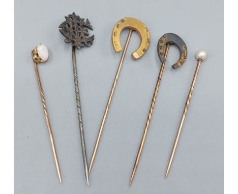 A yellow metal stick pin set oval opal together with another stick pin set single pearl and three other stick pins 
