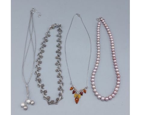 A pink pearl necklace with silver clasp together with a silver marcasite necklace, a silver and amber set necklace and a silv