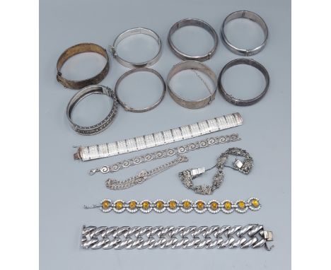 A silver bangle together with other bangles and bracelets 