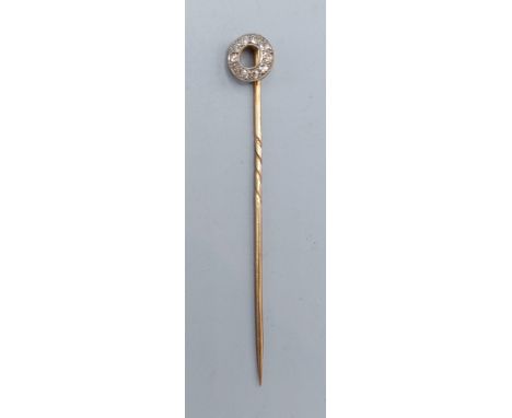 A yellow metal diamond cluster set stick pin 