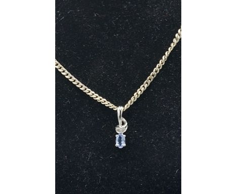 A 9ct white gold Diamond and Topaz set pendant with 925 silver chain 