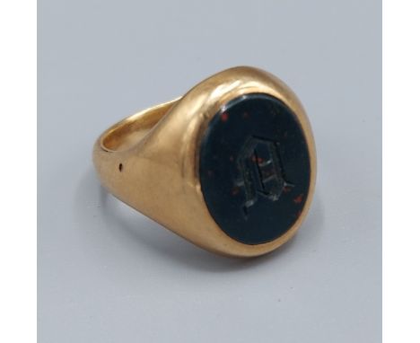 A yellow metal signet ring set oval stone with initials, 11.3gms, ring size P 