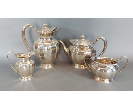 An Edwardian silver four piece tea service comprising teapot, hot water pot, cream jug and two handled sucrier, Sheffield 190