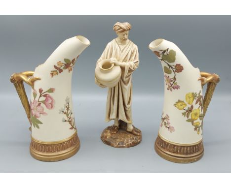 A pair of Royal Worcester blush ivory tusk vases decorated in polychrome enamels and highlighted with gilt, the handles of bo