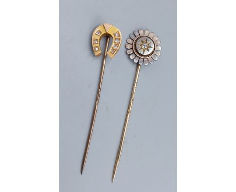 A yellow metal stick pin in the form of a horse shoe, set with six diamonds together with another diamond set stick pin 
