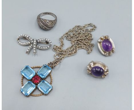 A pair of silver ear studs set with cabochon amethysts together with silver and pearl bow brooch, a silver dress ring and a p