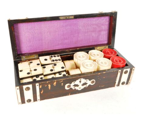 Early 20th century bone draughts and dominoes housed within a wooden box. Domino pieces with ebonised wooden bases, bone tops