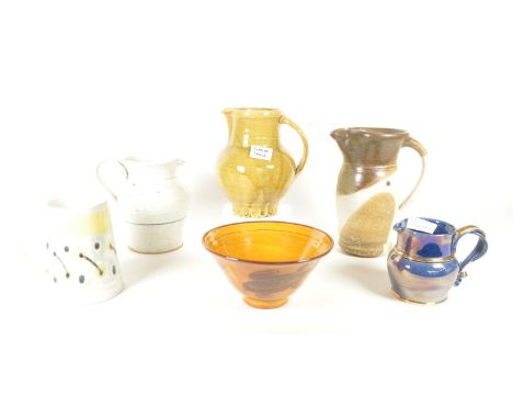 A collection of ceramic studio art pottery. Mainly jugs and one bowl including, Axminster stoneware fish bowl, Simon Leach ju