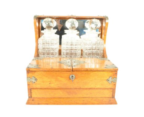 Arts and crafts style 20th century tantalus cabinet with three cut crystal decanters and original key. Decanters complete wit