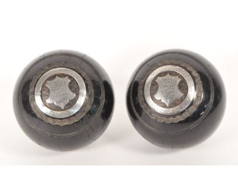 Early 20th century circa 1920s presentation lawn bowls. Having a  sterling silver band and an inscribed shield plaque.