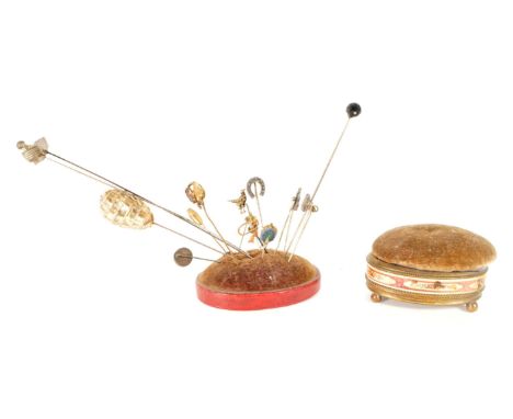 An early 20th century and later hat pin collection with pin cushion on wooden base and pin cushion box. Pins including beehiv