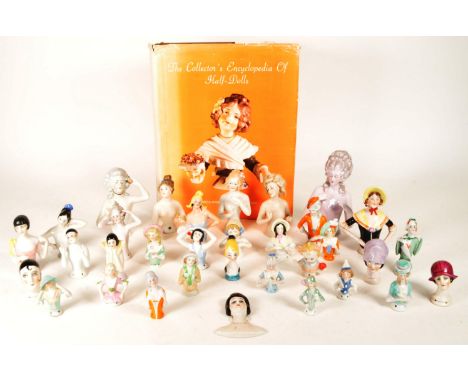 Collection of various 20th century porcelain pin cushion half dolls and The Collector's Encyclopedia of Half-Dolls by Freida 