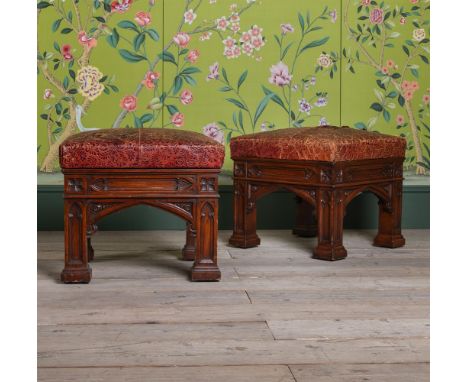 A PAIR OF VICTORIAN OAK STOOLS IN THE MANNER OF A. W. N. PUGIN, CIRCA 1860 Upholstered in embossed leather, the feet with rec
