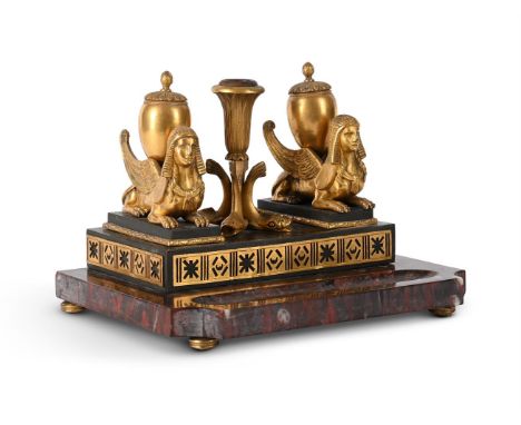 AN EGYPTIAN REVIVAL GILT BRONZE MOUNTED ROUGE GRIOTTE MARBLE INKSTAND  FRENCH OR ITALIAN, LATE 19TH CENTURY  With inkwells su