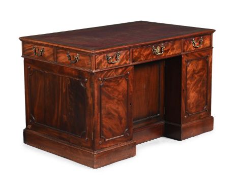 A GEORGE III MAHOGANY DESK IN THE MANNER OF THOMAS CHIPPENDALE, CIRCA 1790 The central drawer with a sliding leather inset wr