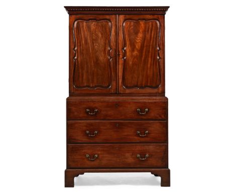 A GEORGE III MAHOGANY SECRETAIRE CLOTHES PRESS IN THE MANNER OF PHILLIP BELL OR HENRY KETTLE, CIRCA 1760 The serpentine panel