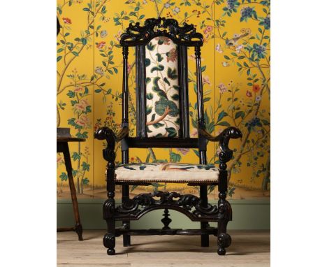 A WILLIAM & MARY LIGNUM VITAE ARMCHAIR LATE 17TH CENTURY The back and seat with linen and wool crewel work fabric 137cm high,