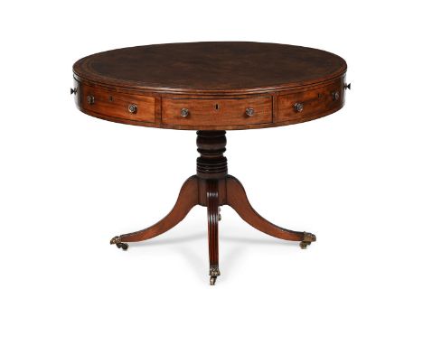 Y  A GEORGE III MAHOGANY AND LEATHER INSET DRUM LIBRARY TABLE CIRCA 1800 With four ebony strung frieze drawers and four false
