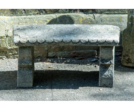 A SMALL CARVED COTSWOLD STONE BENCH EARLY 20TH CENTURY 43cm high, 92cm wide, 43cm deep  Condition Report:  Weathering and wea