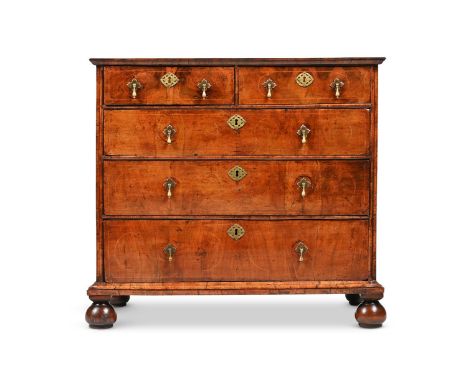 A QUEEN ANNE FIGURED WALNUT CHEST OF DRAWERS CIRCA 1710 The quartered top crossbanded and inlaid throughout with holly string