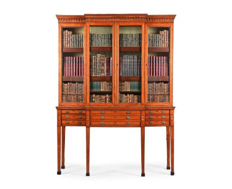 Y  A GEORGE III SATINWOOD AND TULIPWOOD CROSSBANDED BREAKFRONT SECRETAIRE CABINET CIRCA 1790 The glazed doors enclosing a taf