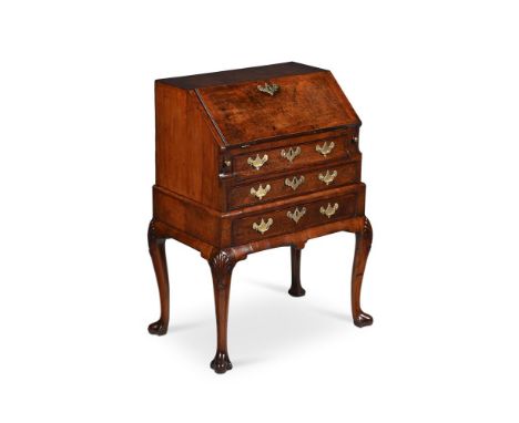 A FINE GEORGE II BURR WALNUT, WALNUT AND FEATHERBANDED BUREAU ON STAND  CIRCA 1730  The interior fittings with parquetry, wit