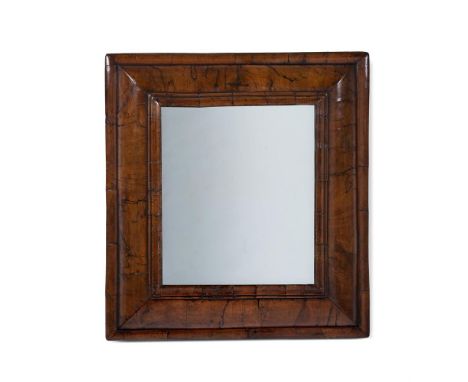 A WILLIAM & MARY WALNUT 'CUSHION' FRAME MIRROR CIRCA 1690 57.5cm high, 52cm wide  Condition Report:  Frame with the marks, kn