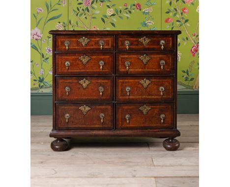 A WILLIAM & MARY BURR ELM CHEST OF DRAWERS CIRCA 1710 Herringbone banded, of small proportions, with an unusual arrangement o