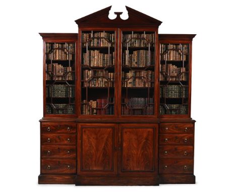 A GEORGE III MAHOGANY BREAKFRONT LIBRARY BOOKCASE CIRCA 1770 The glazed top with adjustable shelves, the base with oak lined 