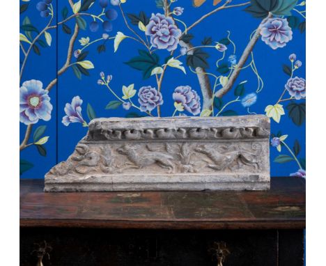 A SECTION OF CARVED STONE FRIEZE  POSSIBLY 17TH CENTURY  With stiff leaf frieze above two running animals, dog in pursuit pos