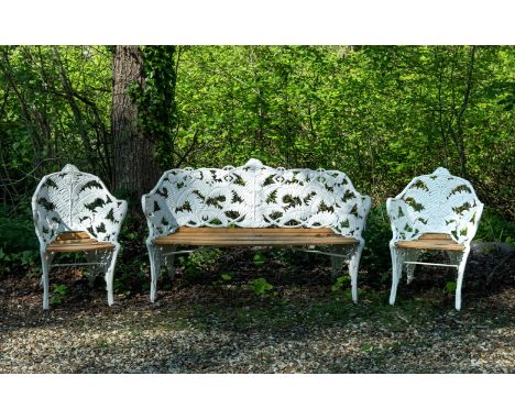 A THREE PIECE VICTORIAN CAST IRON GARDEN SET IN THE COALBROOKDALE FERN PATTERN  LATE 19TH CENTURY  The bench by Goss & Peene,