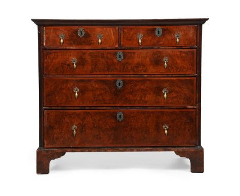 A GEORGE I FIGURED WALNUT AND FEATHERBANDED CHEST OF DRAWERS CIRCA 1725 92cm high, 104cm wide, 57.5cm deep  Provenance: Barga