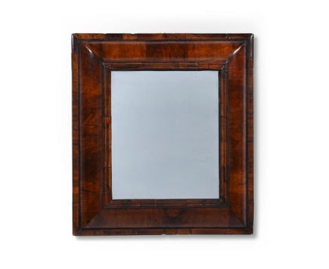 A WILLIAM & MARY FIGURED WALNUT CUSHION FRAMED MIRROR CIRCA 1690 65cm high, 59.5cm wide   Condition Report:  Frame with the m