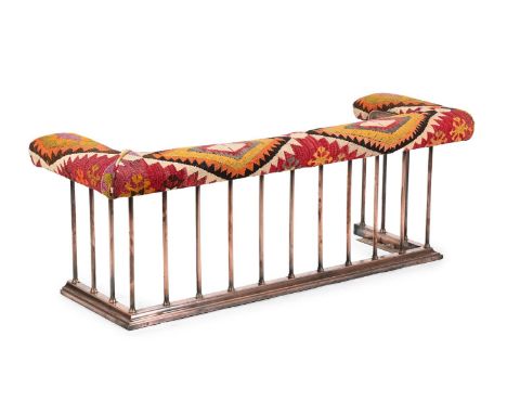 A POLISHED COPPER AND KILIM UPHOLSTERED CLUB FENDER  20TH CENTURY  externally 56cm high, 160cm wide, 53cm deep  internally at