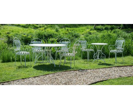 A SUITE OF HAND FORGED AND WHITE PAINTED GARDEN FURNITURE CONTEMPORARY Comprising two tables and six sprung armchairs the lar