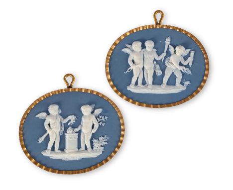 A PAIR OF WEDGWOOD & BENTLEY SOLID BLUE JASPER GILT METAL MOUNTED OVAL PLAQUES SPRIGGED IN WHITE WITH PUTTI CIRCA 1775 Decora