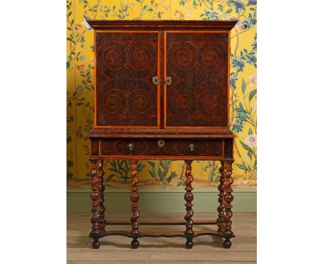 A FINE WILLIAM & MARY OLIVEWOOD OYSTER VENEERED CABINET ON STAND  CIRCA 1690 With holly banding and inlay, the doors opening 
